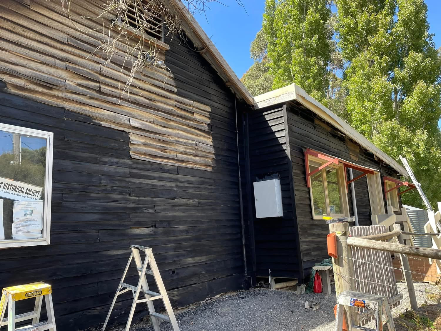 The Police Stables building being re-sealed and painted by committee members